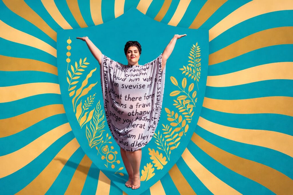 Plus-size woman in a flowing text-covered dress stands triumphant with arms raised wide against a bold teal and gold sunburst background, surrounded by golden botanical illustrations, celebrating body liberation and unapologetic presence