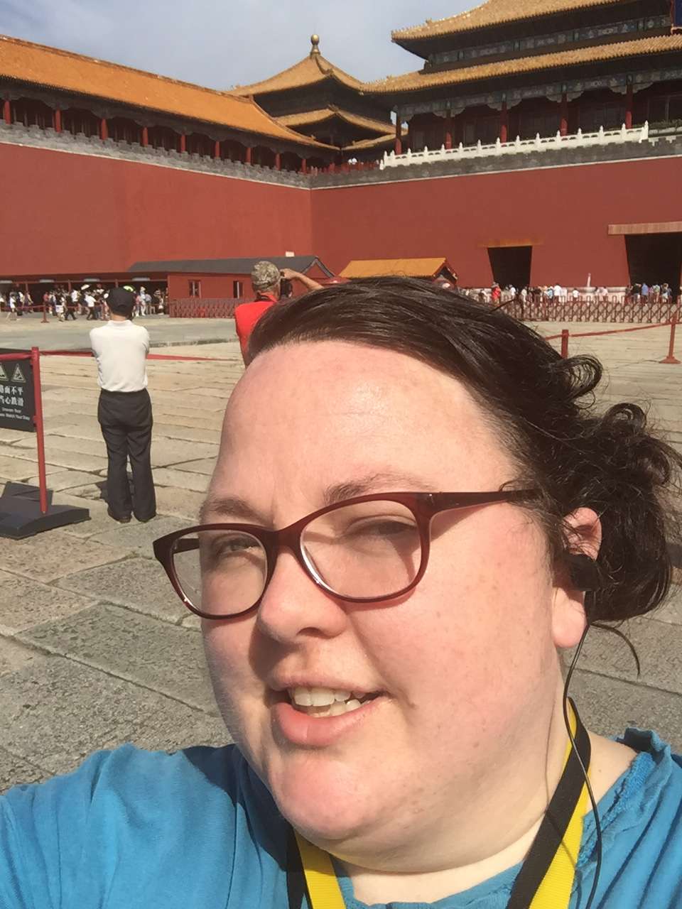 Woman smiling at the Forbidden City in Beijing with traditional Chinese architecture in background, taken before website security crisis
